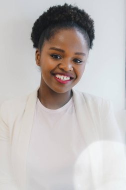 Smiling attractive African American businesswoman looking straight in to camera. Concept of model, successful business person
