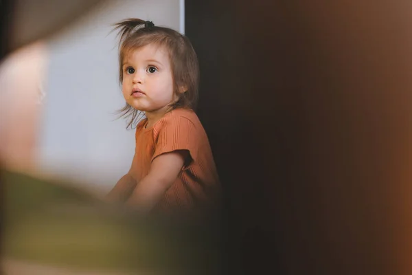 Distant View Cute Little Girl Focused Looking Distance Leaning Sofa —  Fotos de Stock