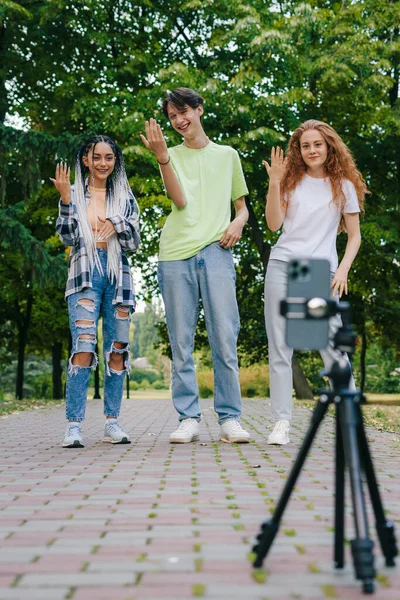 Trendy smiling teenagers vlogger dancing and recording video stream for TikTok. Summer vacation. Gen Z .
