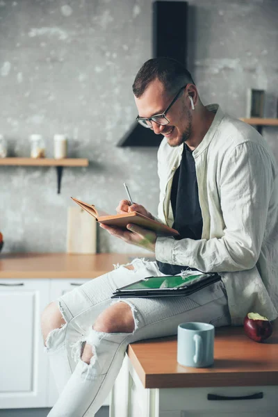 Portrait Positive Businessman Enjoying Work Home Kitchen Writing Plans Week — Stockfoto