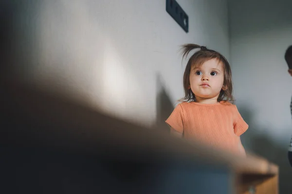 Baby Girl Standing Sofa Watching Living Room Portrait Kid Face —  Fotos de Stock