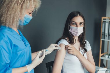 Nurse using a cotton with alcohol to wipe the upper arm of the patient. to prepare for vaccinations. Medicine medical health. Pandemic prevention. COVID-19
