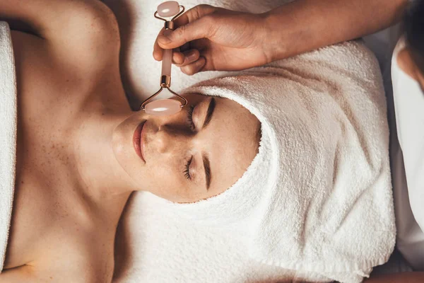 Close Portrait Beauticians Hand Massaging Patients Face Jade Roller Spa — Fotografia de Stock