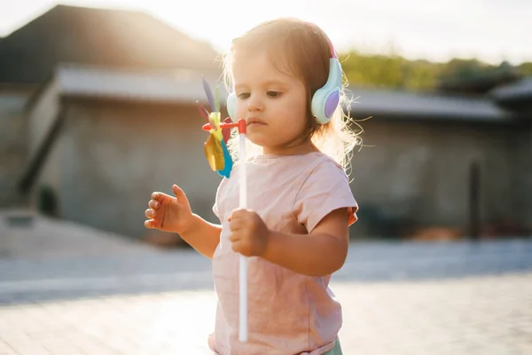 Girl Standing Weathervane Her Hand Looking Happily Her New Toy — Stock Photo, Image