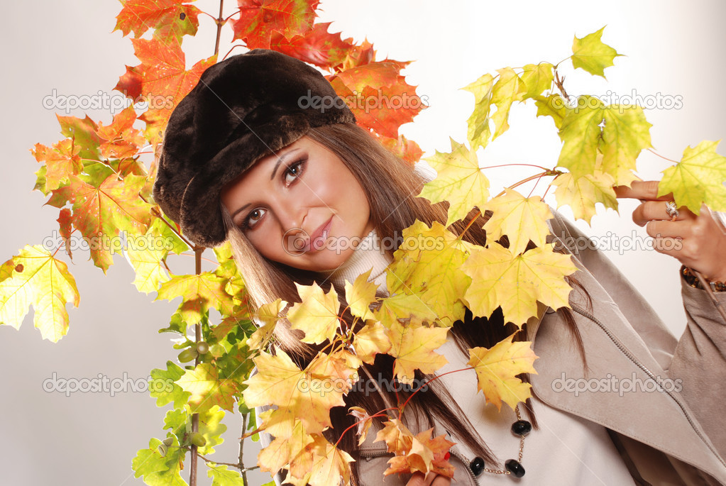 Portrait of beautiful girl with autumn leaves