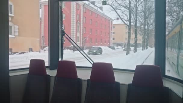 Helsinki tram on the street in winter during strong snowfall — Stock Video