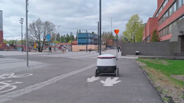 The Starship delivery robot is moving by the pedestrian path, Espoo, Finland. — стоковое видео