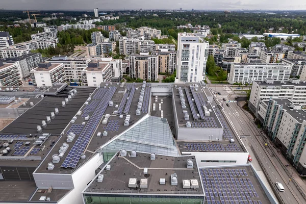 Aerial view of the solar panels on the roof of a shopping mall building in Finland. Modern residential architecture.