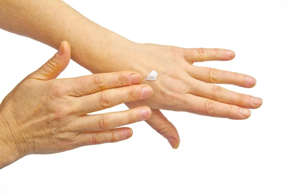 Female hands applying hand cream — Stock Photo, Image