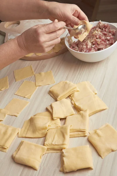 Woman doing trickled pastries of meat on home cuisine — Stock Photo, Image