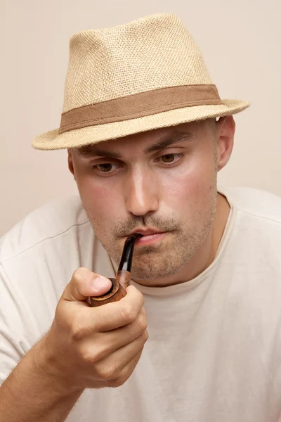 Young attractive man with tube smoking — Stock Photo, Image