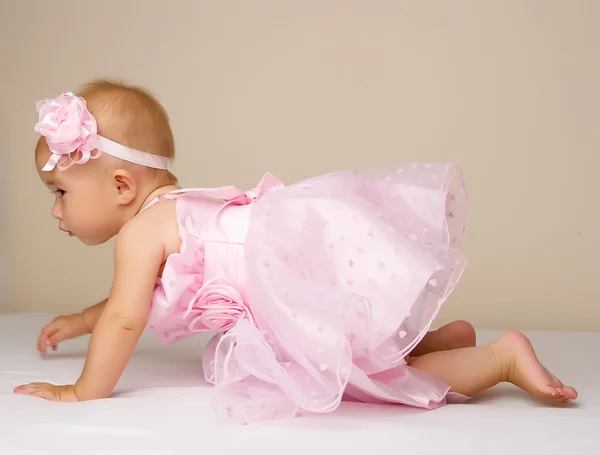 Meisje van de baby in roze jurk. — Stockfoto