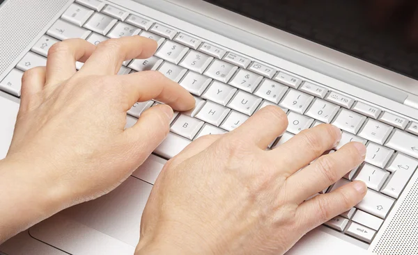 Female hands printing on the keypad a laptop — Stock Photo, Image