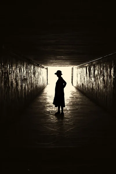 Silhouette of woman in a tunnel. — Stock Photo, Image