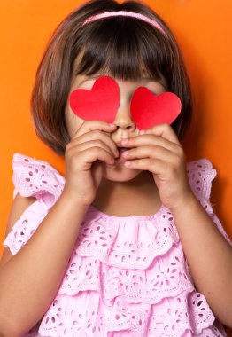 Little girl and red hearts. clipart