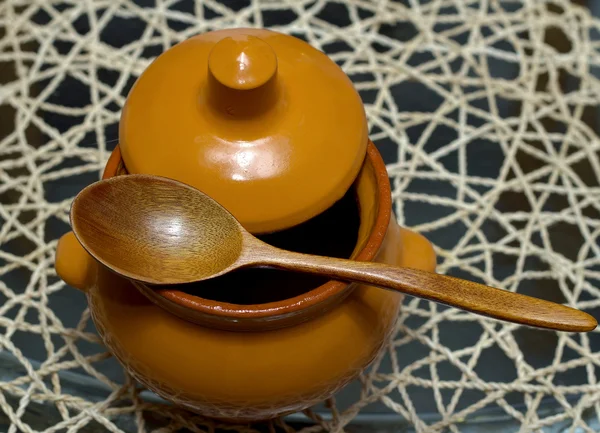 Olla de cerámica con una cuchara de madera — Foto de Stock