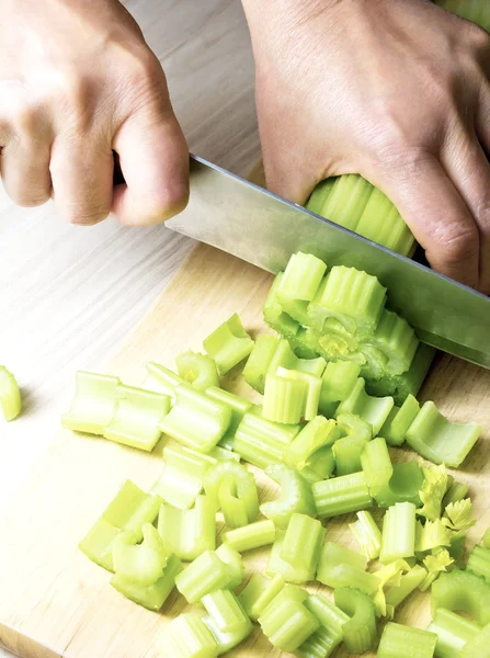 Woman hands cut the celery — Stock Photo, Image