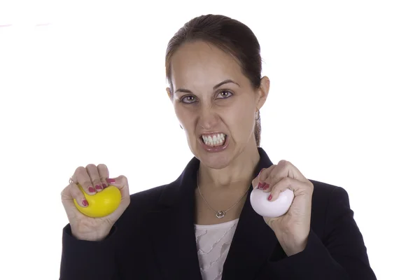 Angry business woman with stress balls — Stock Photo, Image