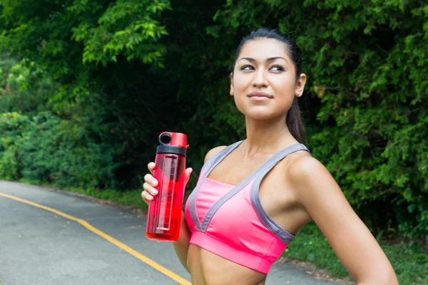 Fit young woman with water bottle after running — Stock Photo, Image