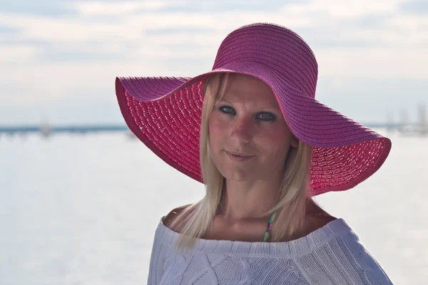 Young woman with a pink sun hat — Stock Photo, Image