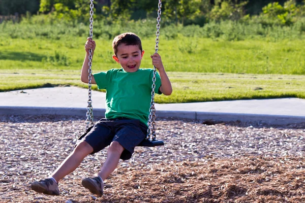 Child playing on the swing — Stock Photo, Image