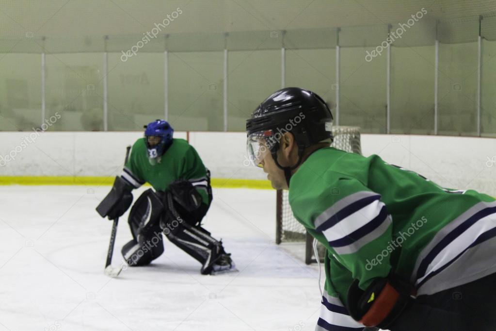 Ice Hockey goaltender and defensemen at the face-off