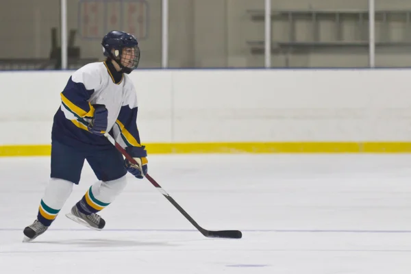 Female ice hockey player in game action