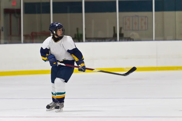 Female ice hockey player in game action