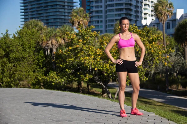 Confident and fit hispanic woman in a sports bra — Stock Photo, Image