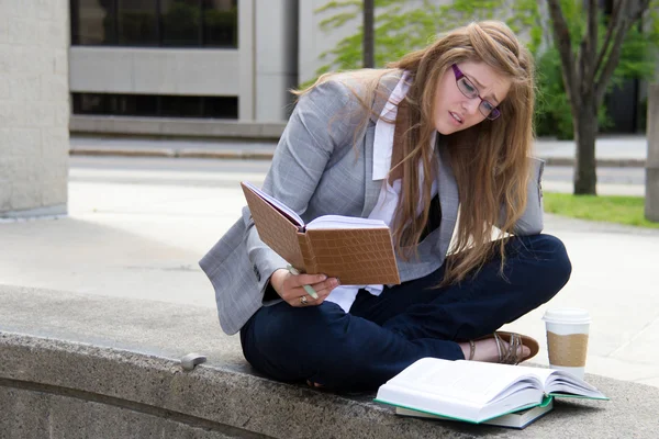 Stressed student studying on campus — Stock Photo, Image