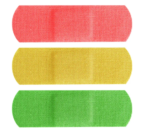 Bandaids vermelho amarelo e verde — Fotografia de Stock