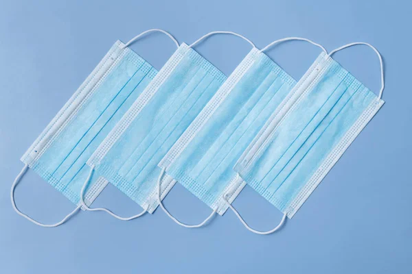 Several Medical Protective Masks Lying Row Light Blue Background — Fotografia de Stock