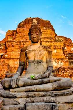 Buddha image in front of prang at Wat Mahathat, Ayutthaya, Thailand