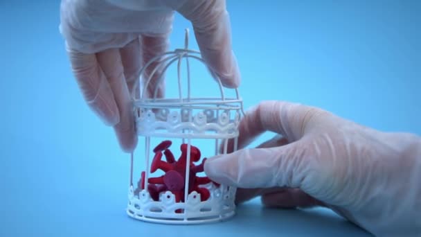 Een hand in een handschoen haalt het coronavirus uit een metalen gevangenis. Het concept om biologische wapens te maken. Gevaar voor de mensheid. Nieuwe stammen van het coronavirus. Omicron — Stockvideo