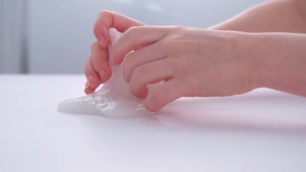 Childrens hands close-up. The child plays with a sticky toy. Stress relief. Nice toy. Relaxation and recovery. — Stock Video