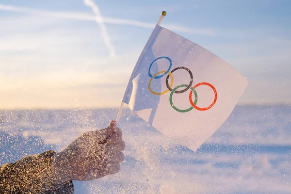 Olympic Flag Small Hand Flutters Backdrop Snow Trees Concept Winter — Stock Photo, Image