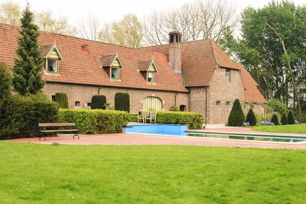 Old brick farm house with swimming pool — Stock Photo, Image