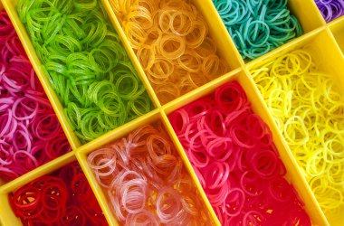 Colorful Rainbow loom rubber bands in a box clipart