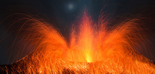 Volcano erupting with strong eruption at night