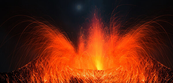 Volcano erupting with strong eruption at night