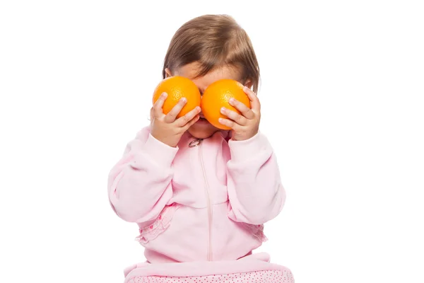 Malá dívka s pomeranči — Stock fotografie