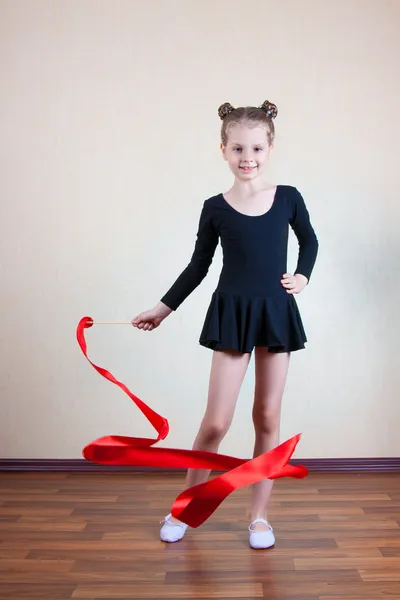 Girl gymnast with red ribbon — Stock Photo, Image