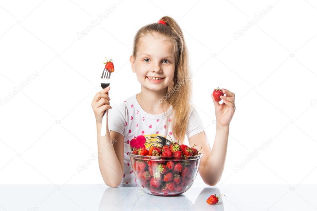 happy girl eating strawberries