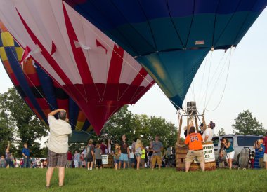 METAMORA, MICHIGAN - AUGUST 24 2013: Colorful hot air balloons launch at the annual Metamora Country Days and Hot Air Balloon Festival. clipart