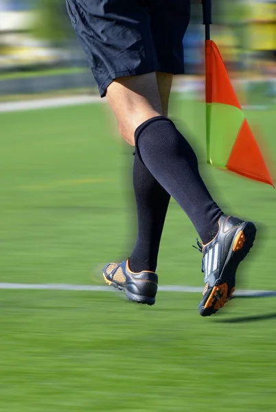 Soccer line judge with flag — Stock Photo, Image