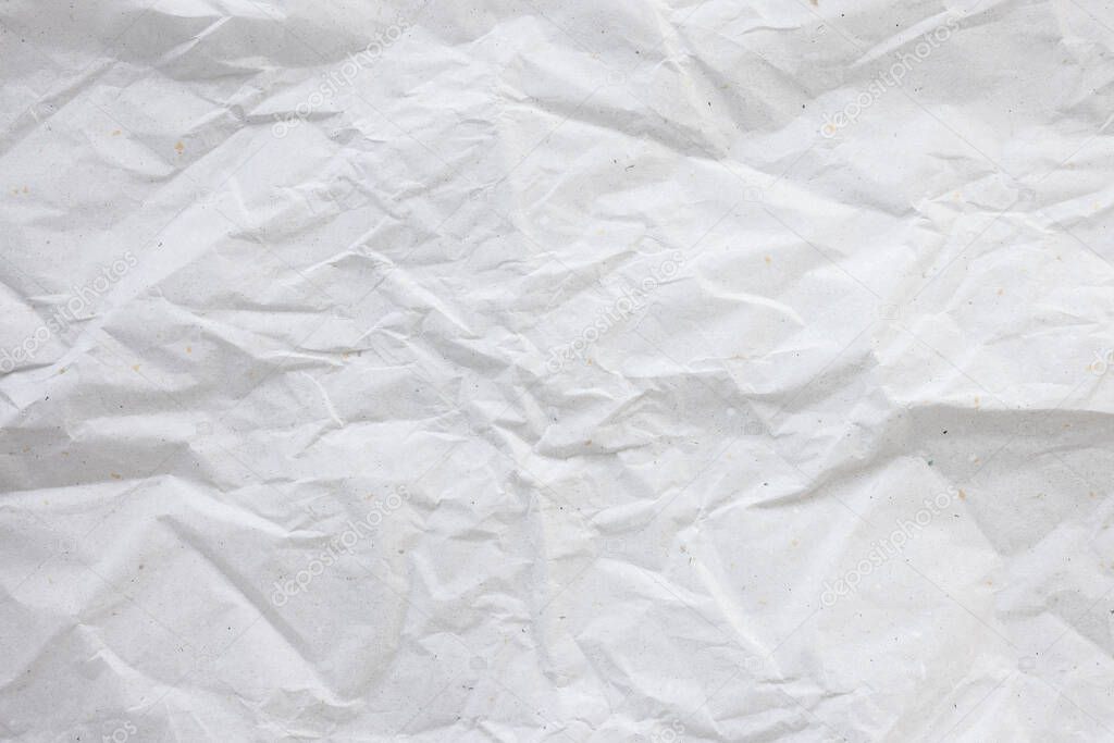 Crumpled used white wrapping paper texture background