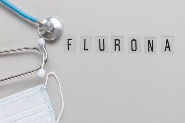 FLURONA 'nın gri arka planı. COVID ve grip çift enfeksiyon konsepti