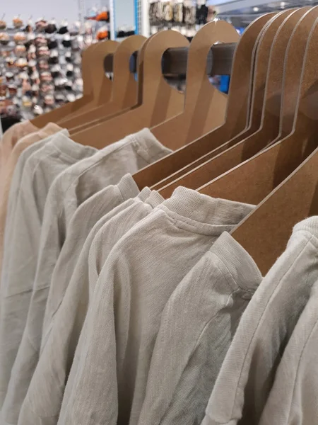 Casual neutral color clothes on a rack in a store — ストック写真