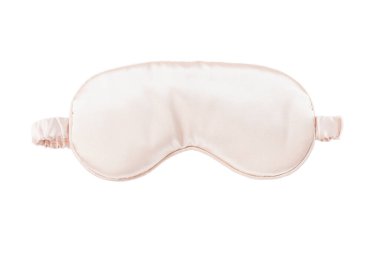 Pink satin eye sleeping mask isolated on white background. Insomnia and sleeplessness disorder concept. Close up, copy space, flat lay. Accessories for girls and women