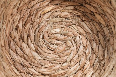 Abstract wicker seagrass basket texture background. Circle spiral pattern. Bottom of natural home storage basket. Close-up, circle spiral pattern